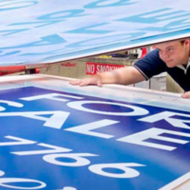 For sale banner in the process of being printed